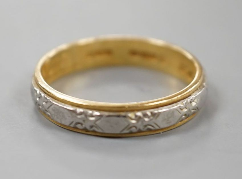 A modern 18ct two colour gold band, size L